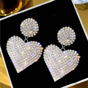 New in package never worn heart shaped rhinestone silver costume earrings